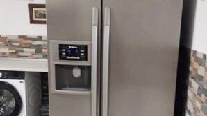 A stainless steel refrigerator with a digital display and a freezer compartment. - Loft Los Olivos in Algar (Algar)