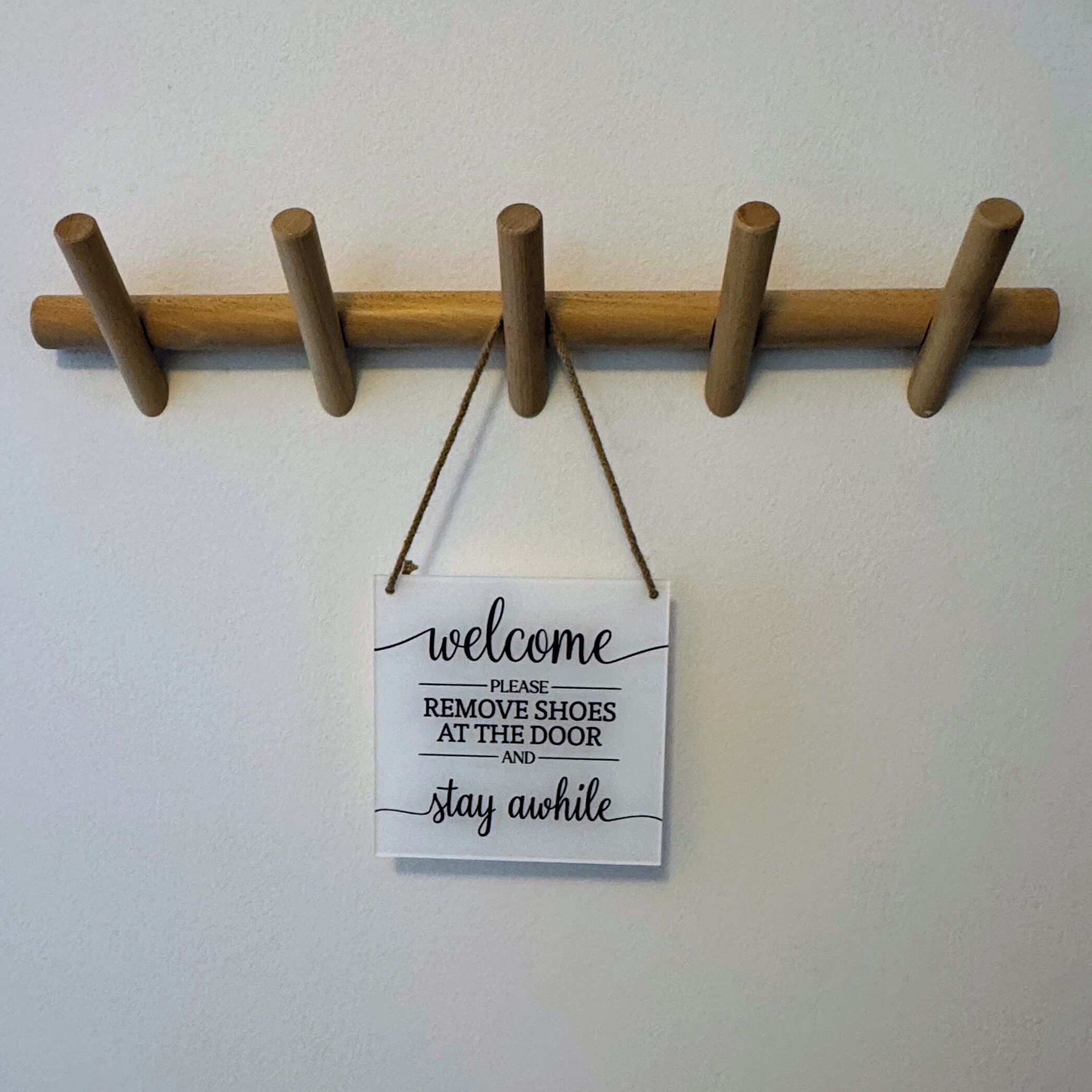A welcome sign with instructions to remove shoes at the door and stay awake.