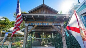 A wooden structure labeled "ADVENTURE GOLF" with an American flag and a state flag.