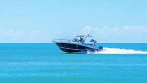 A speedboat on a clear blue sea.