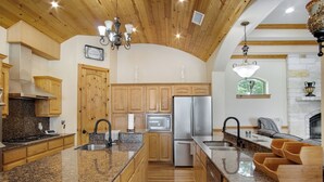 A spacious kitchen with granite countertops, wooden cabinets, stainless steel appliances, and a built-in oven. - Luxury Ranch in Florence-Party House for Families 5 1/2 bedrooms,5bath,Sleeps 20 (Florence)