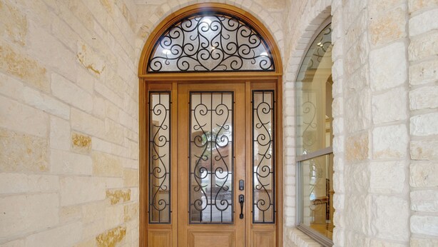 A wooden door with decorative ironwork and a glass panel, set in a stone-walled hallway. - Luxury Ranch in Florence-Party House for Families 5 1/2 bedrooms,5bath,Sleeps 20 (Florence)