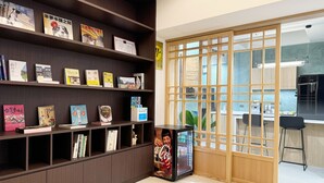 A modern library with bookshelves and a refrigerator. - A Day A Room (Taichung)