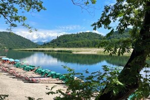 A lakeside view with boats and a dock.