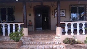 A stone staircase leading to a wooden door, with a white balustrade on the porch. - Boliqueime Villa Private Pool With Ocean View (Loulé)