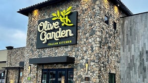 A building with a stone facade and a sign that reads "Olive Garden Italian Kitchen." - Comfortable 6BR Urban Retreat Lgbtq 38 (Oklahoma City)