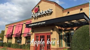 The exterior of Applebee's restaurant at 608, featuring a brick facade, red awning, and a clear sky. - Comfortable 6BR Urban Retreat Lgbtq 38 (Oklahoma City)