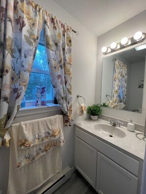 Jetted bath, hair dryer, towels, toilet paper
