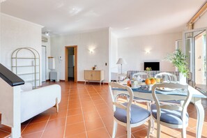 A spacious living area with a dining table, chairs, a sofa, and a TV. - Private Pool Villa Beside Monaco, Beausoleil, France (Beausoleil)