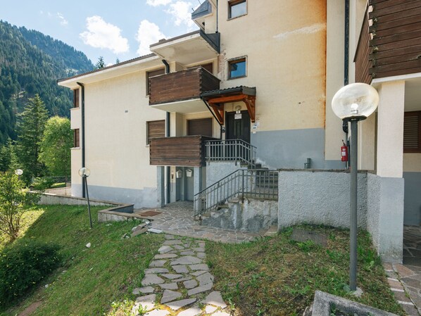 A two-story building with a stone pathway leading to the entrance.