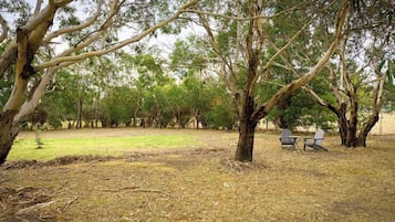 A park with trees and a picnic table.