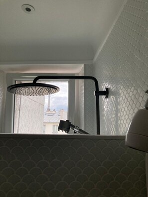A bathroom with a shower, a window, and a patterned wall. - Ava's dream -Near Eiffel Tower- by Mon Petit Faré (Paris)