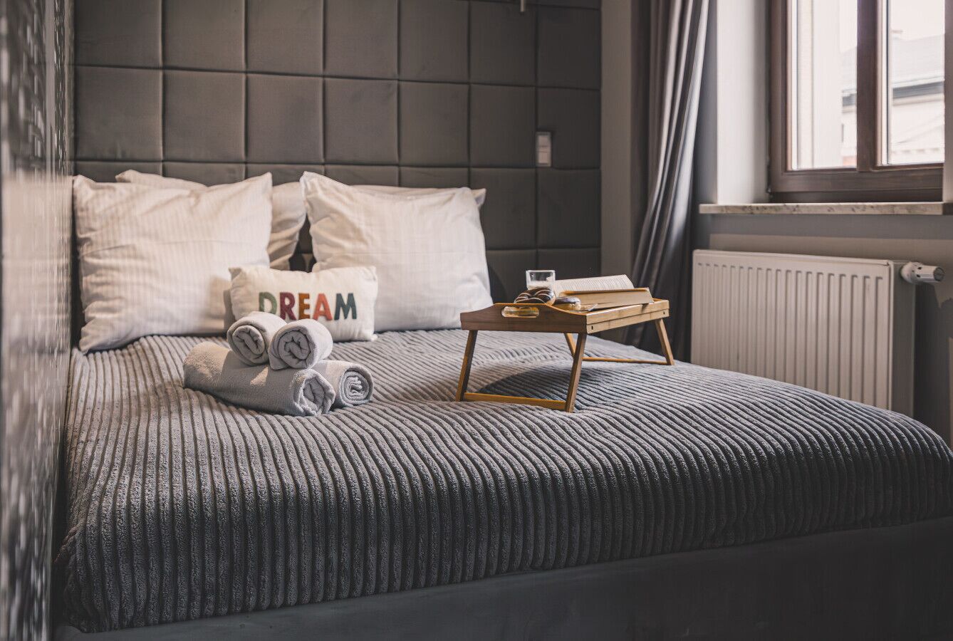 A comfortable bed, ambient lighting, and a decorative wall. A perfect place to relax in the heart of the city.