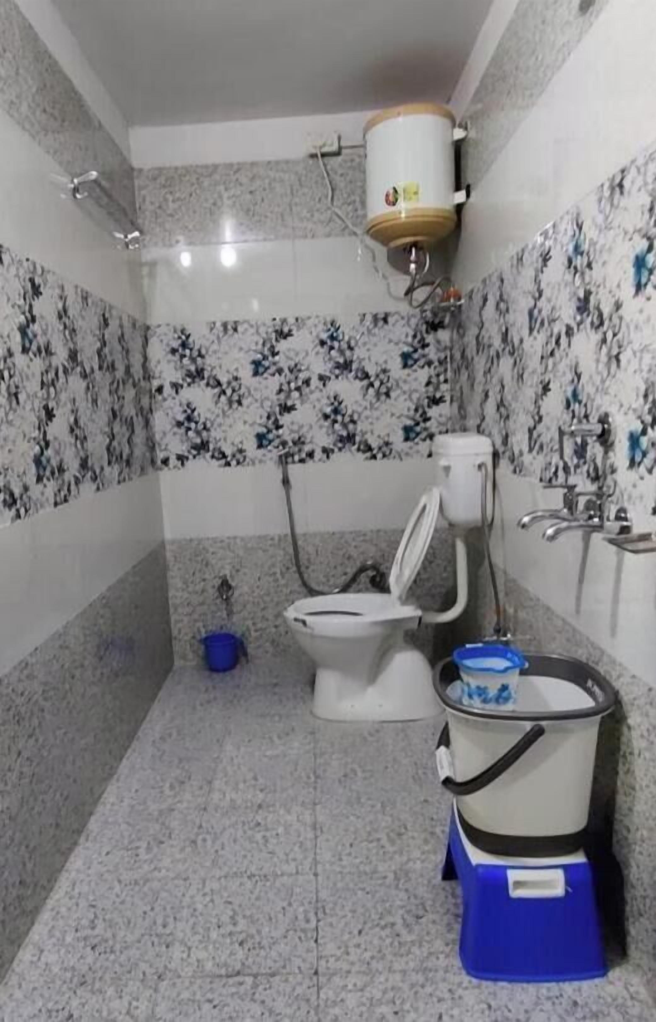 A bathroom with a toilet, bidet, and a water heater.