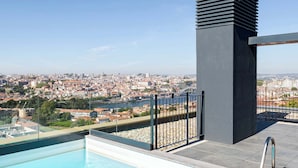 A rooftop pool with a clear view of a cityscape.