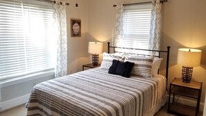 Cozy retreat with a large bed, two bedside tables, and a wall-mounted artwork.