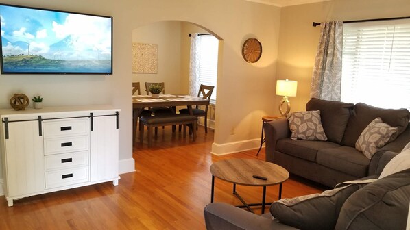 Relax in a comfortable living space with a flat-screen TV, dining area, and functional furniture.