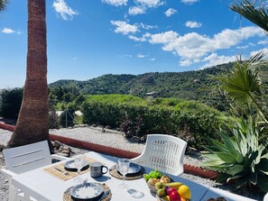 Enjoy a romantic dinner for two amidst lush greenery and a scenic vineyard view.