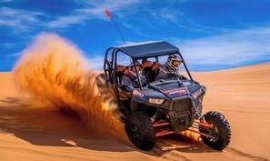 A vehicle driving through a desert with sand being kicked up. - Near Zion: Pool, Hot Tub & Pickleball Fun! (Kanab)