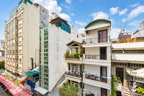 A multi-story building with balconies and a restaurant on the ground floor. - KOVA Hotel - Bui Vien Central (Ho Chi Minh City)