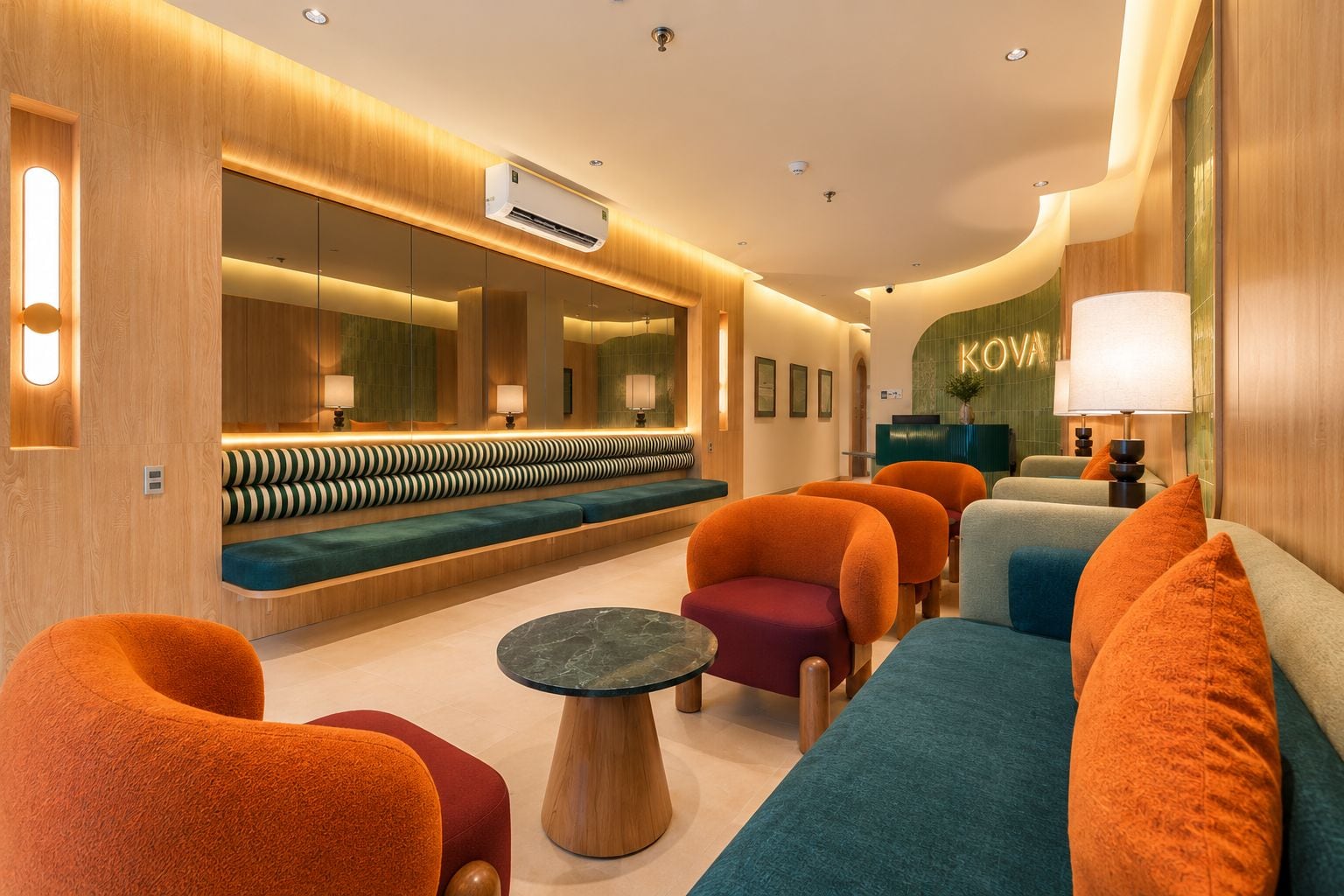 A modern lounge area with a sofa, chairs, and a round table.
