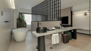 A modern kitchen with a large island, a black grill, and a white sink. - K.Space KaiShi hotel (Guangzhou)