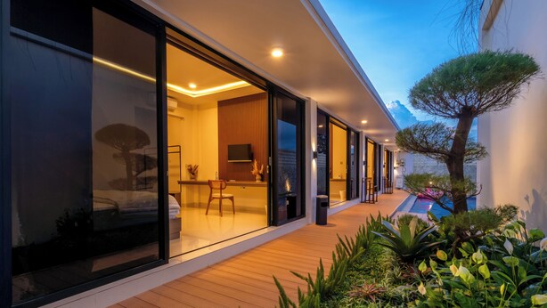 A modern house with a wooden deck, a dining area, and a small pool. - Luxury 5-bedroom villa in beautiful West Java with AC, WiFi, Private Pool (West Java)