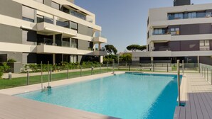 A modern apartment complex with a swimming pool, balconies, and a well-maintained garden. - Bah a Blanca II 18923 (El Puerto de Santa Maria)