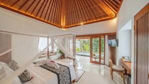 A bedroom with a canopy bed, a dining area with a table and chairs, and a view of a pool. - Daruma Villa Sebatu (Sebatu)