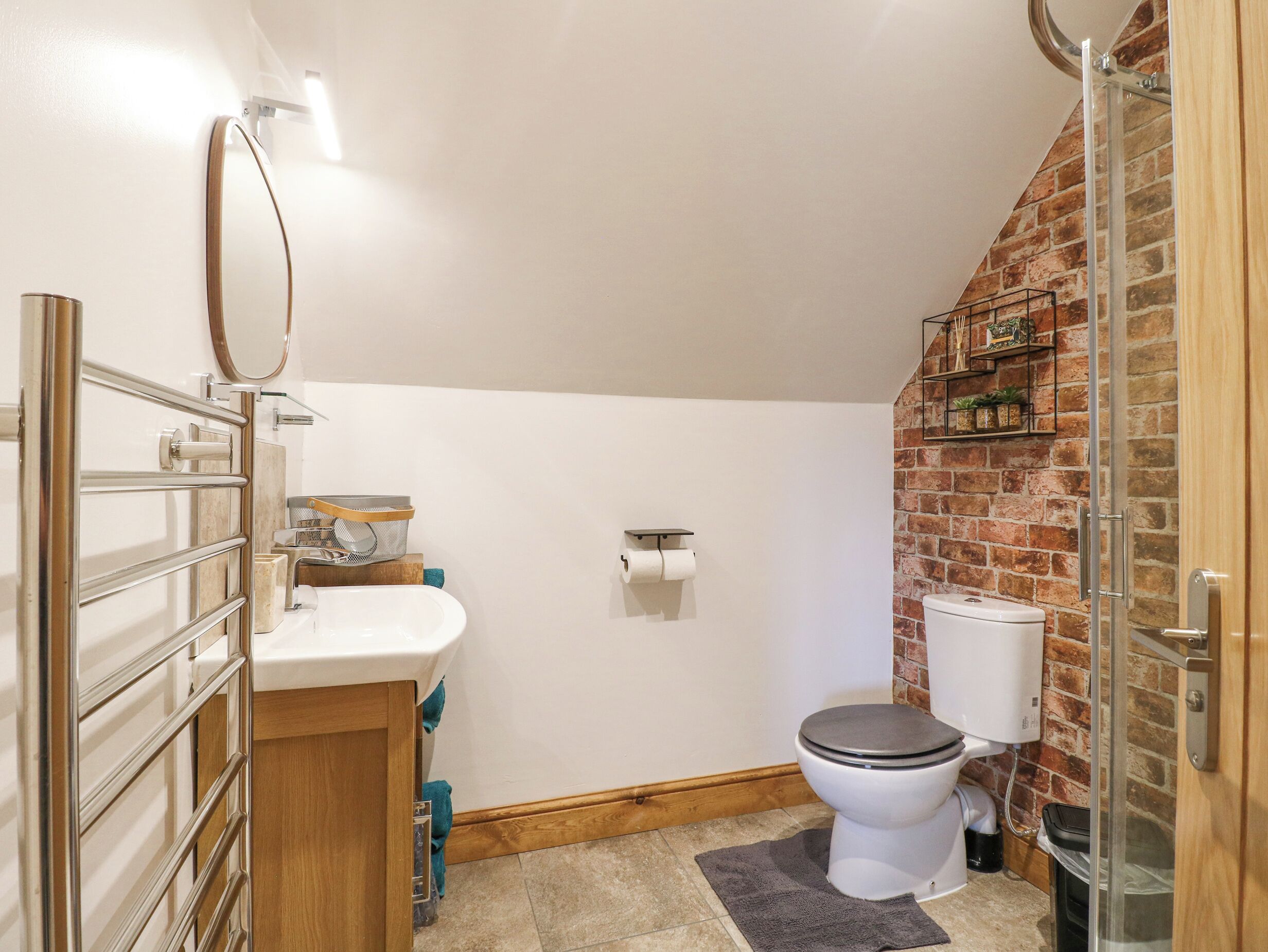 A bathroom with a toilet, sink, and shower.