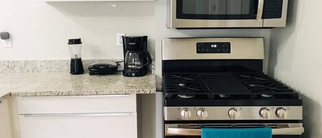 Fridge, coffee/tea maker, cookware/dishes/utensils, paper towels