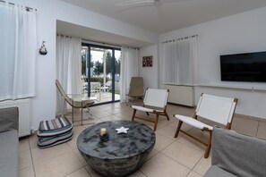 Deluxe Villa, Partial Sea View | Living area | 4-inch Smart TV with cable channels - Niki Seaview Villa DPS27 (Paralimni)