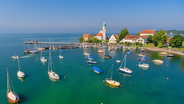 A harbor with boats, a church, and residential buildings.