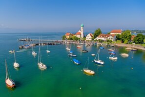 A harbor with boats, a church, and residential buildings.