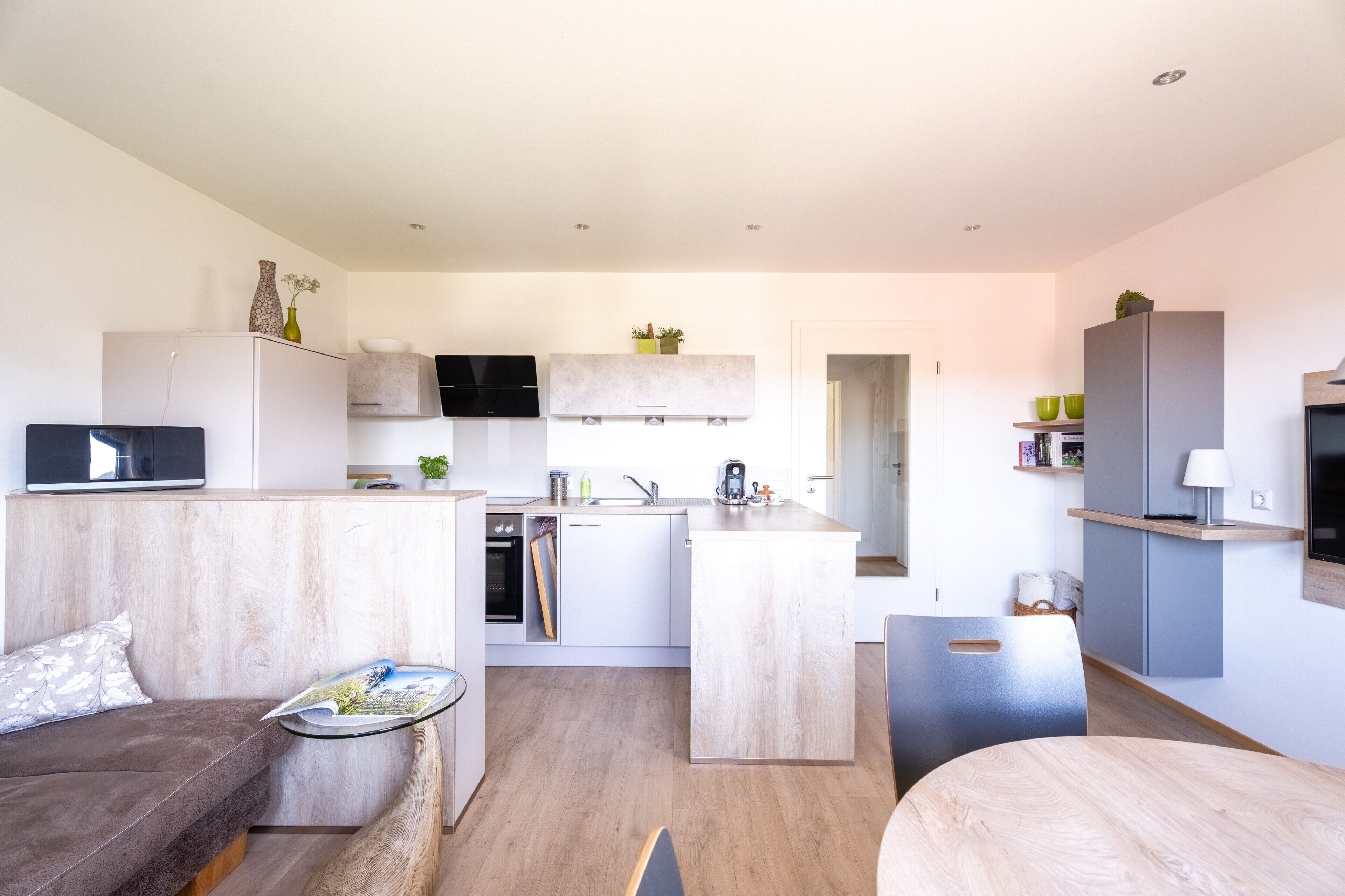 Eine moderne Wohnung mit Küche, Essbereich und Wohnzimmer.