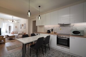 Superior Apartment, Balcony, City View | Living area | 49-inch TV with cable channels