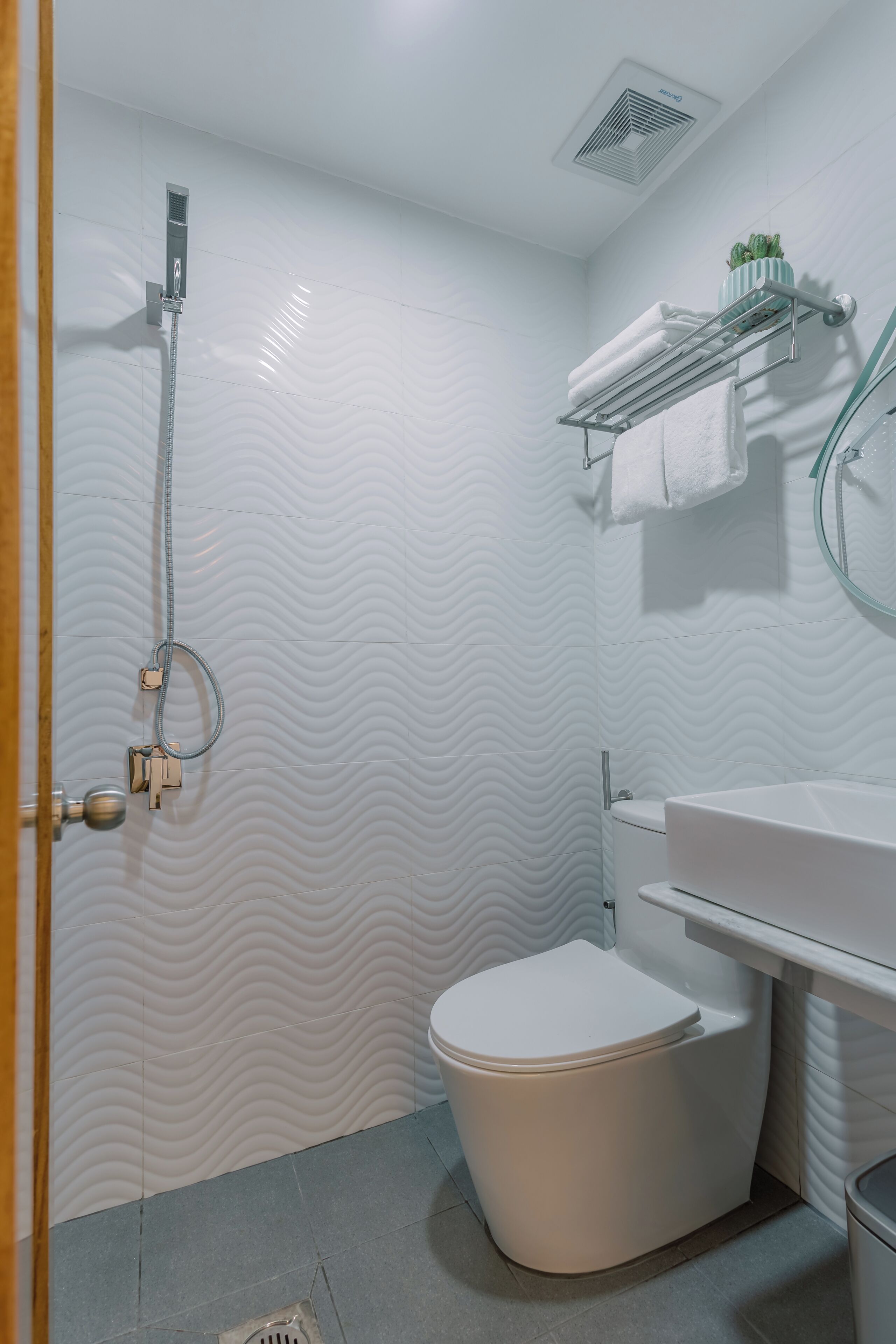 A bathroom with a shower, toilet, and sink.