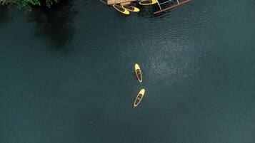 Two kayaks on a calm body of water.