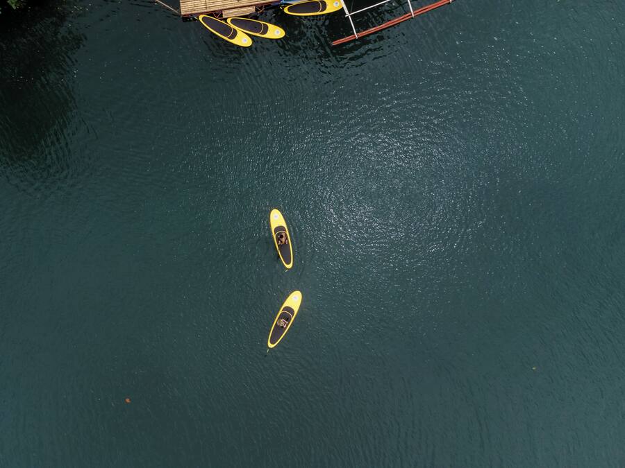 Two kayaks on a calm body of water.