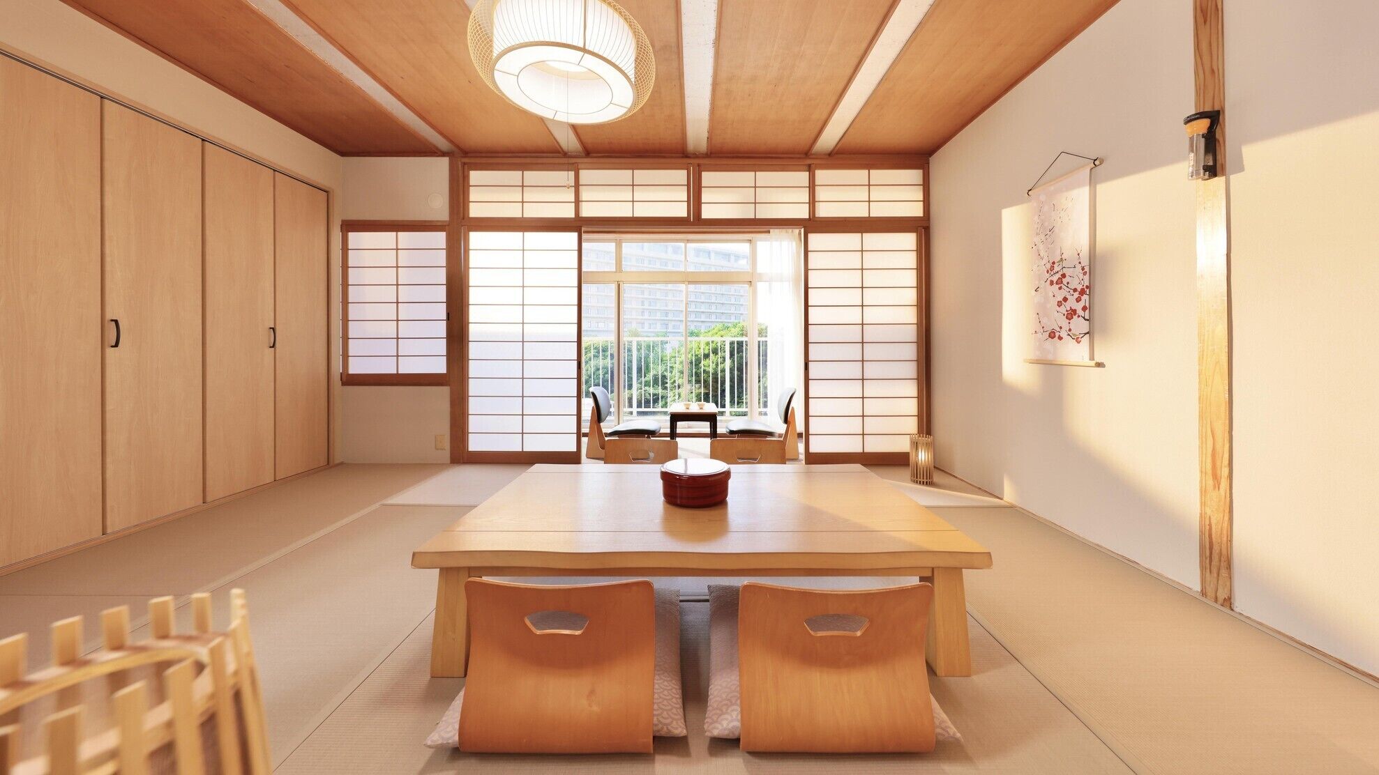 A traditional Japanese-style room with tatami flooring, a low table, and sliding doors.