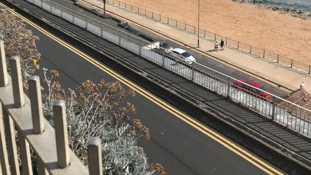 A coastal road with a beach on one side and a pedestrian walkway. - The Old Dairy with Parking - Dog Friendly (Ramsgate)