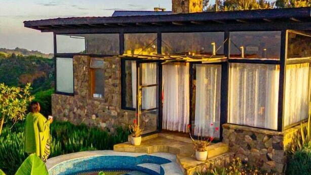 A stone house with a swimming pool, surrounded by lush greenery. - ol eburru cottage naivasha (Naivasha)