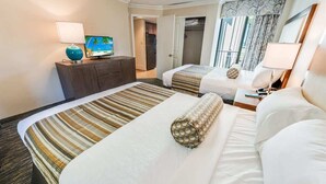A hotel room with two beds, a TV, a dresser, and a closet. - Direct Oceanfront at Coral Beach,Nice,Heated Pools (Myrtle Beach)