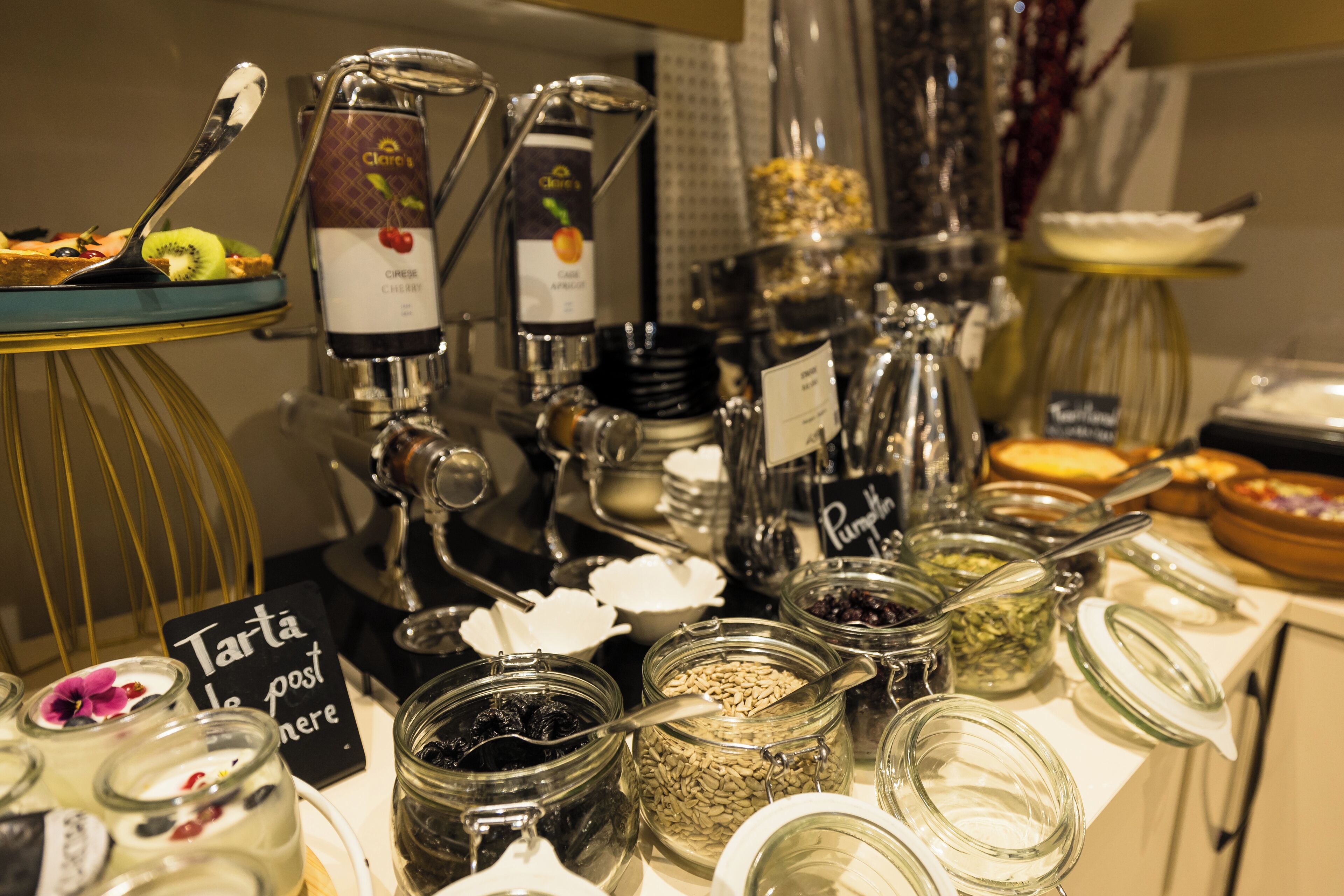 A buffet with various food items and condiments.