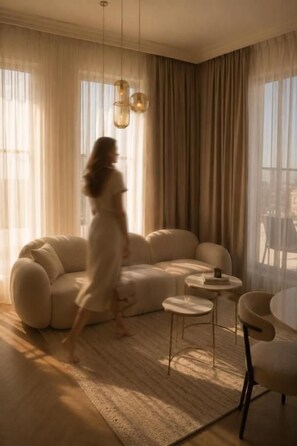 A modern living room with a sofa, a coffee table, and a chair. - Le Blanc Cotroceni hotel (Bucharest)