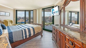 A bedroom with a bed, a dresser, a mirror, and a sliding glass door leading to a balcony. - Newly Added - City Views - Private Maisons Sur Mer (Myrtle Beach)