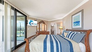 A hotel room with a large bed, a TV, a sliding glass door, and a view of the outside. - Newly Added - City Views - Private Maisons Sur Mer (Myrtle Beach)