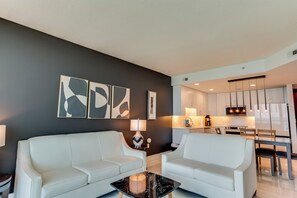 A modern living room with a sofa, coffee table, and abstract wall art.
