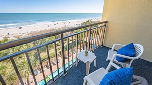A balcony with a view of a beach and pool area. - Direct Ocean Front, The Pavilion, Pools, Boardwalk (Myrtle Beach)
