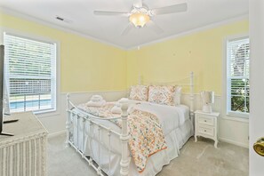 A bedroom with a white bed, a ceiling fan, and two windows with blinds. - Private Saltwater Pool, No Stairs, Sleeps 8, Bunk Bed, Games, Gym, Near Beaches! (Wilmington)